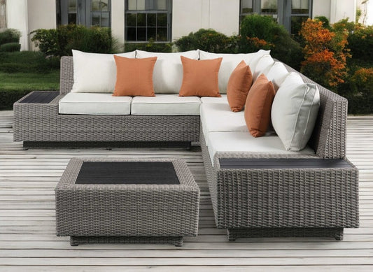 Conjunto modular de cuatro piezas en forma de L de poliéster beige con consola y cojines