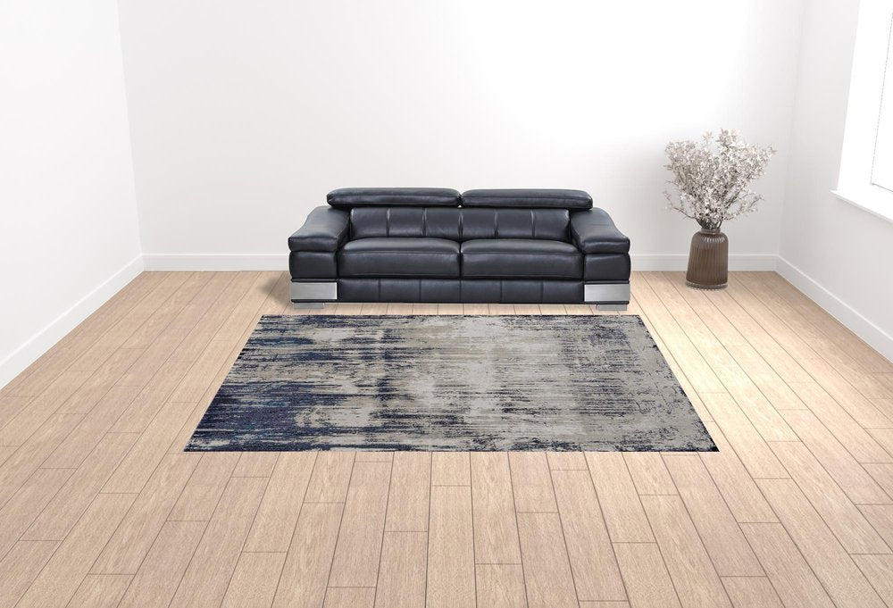 9' X 12' Tan Blue And Ivory Abstract Power Loom Distressed Area Rug