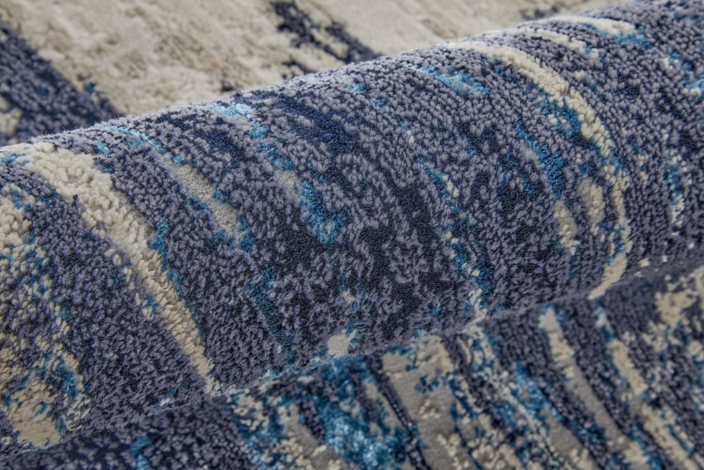 9' X 12' Tan Blue And Ivory Abstract Power Loom Distressed Area Rug