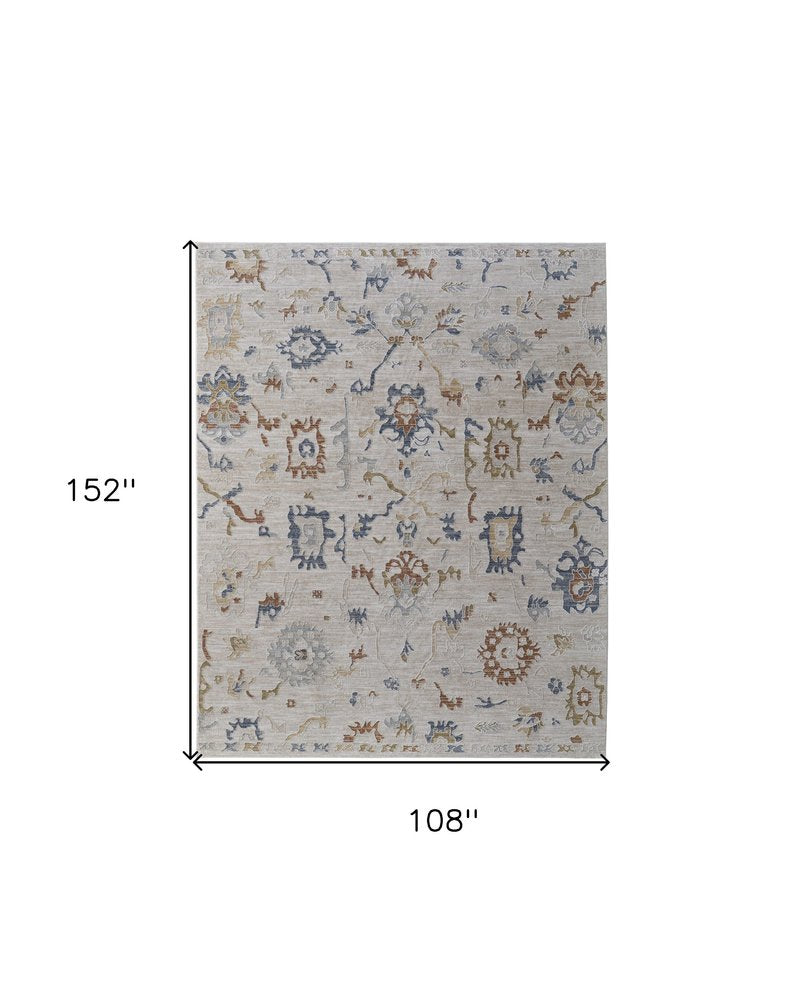 9' X 13' Ivory Blue and Gold Floral Power Loom Worn Faded Area Rug With Fringe