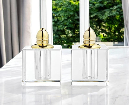 Juego de dos pimenteros de cristal transparente y dorado