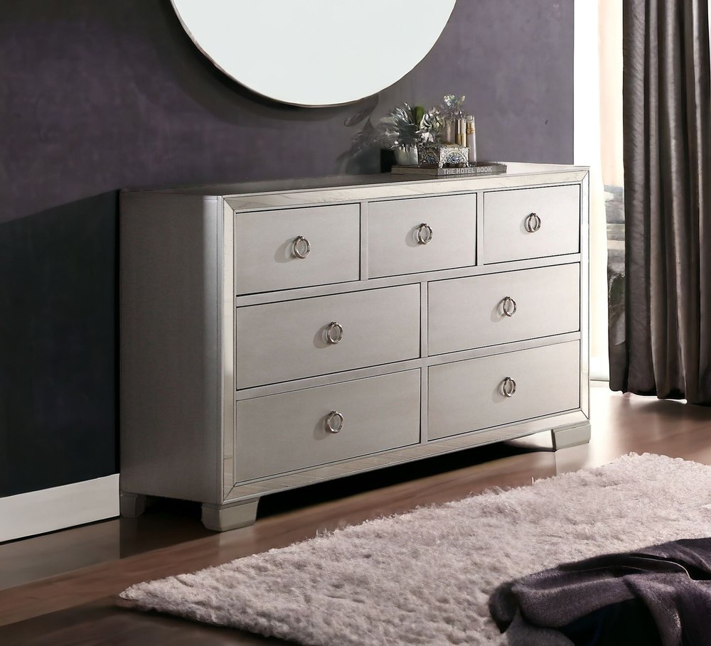 Cómoda triple de siete cajones de madera maciza y manufacturada color platino de 57"
