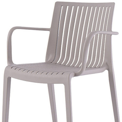 Juego de cuatro sillas apilables para exteriores de plástico resistente color topo de 22"