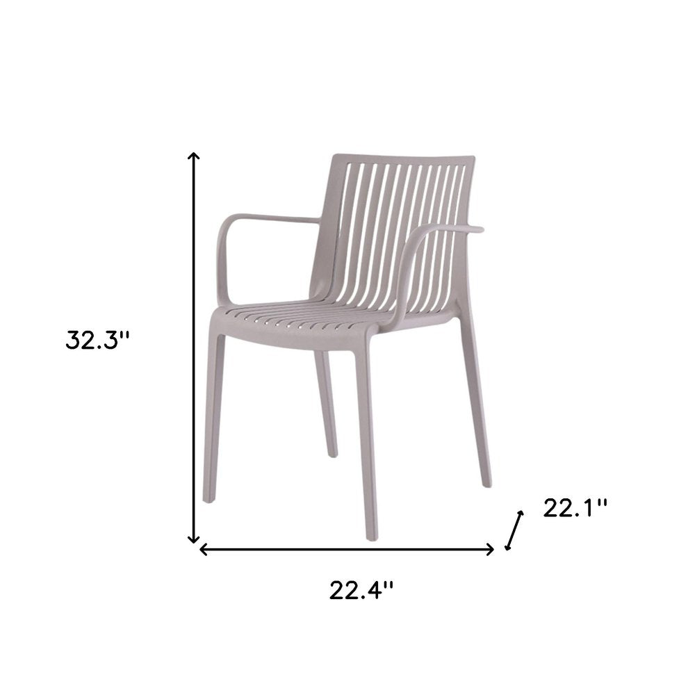 Juego de cuatro sillas apilables para exteriores de plástico resistente color topo de 22"