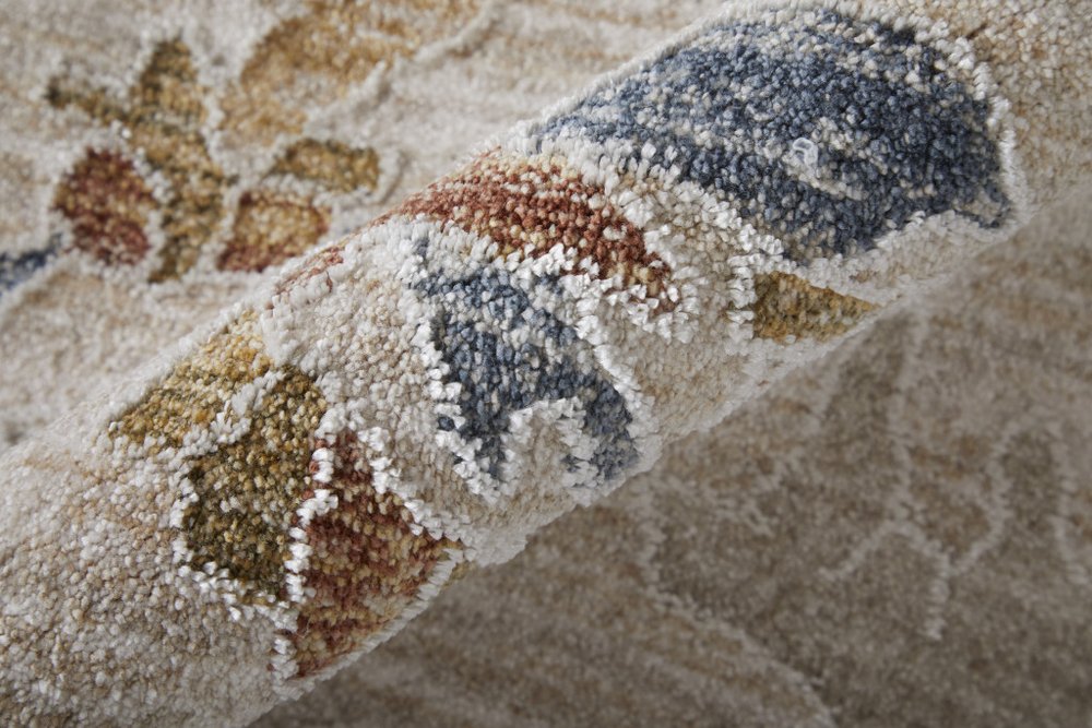 9' X 13' Ivory Blue and Gold Floral Power Loom Worn Faded Area Rug With Fringe
