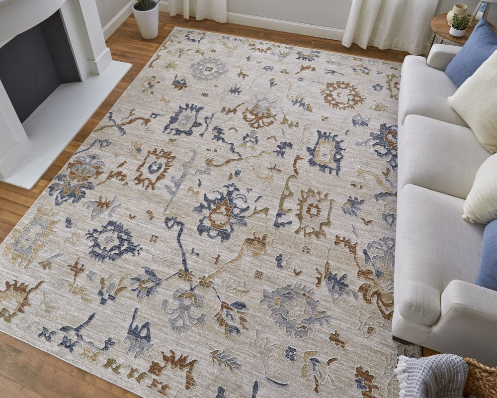 9' X 13' Ivory Blue and Gold Floral Power Loom Worn Faded Area Rug With Fringe