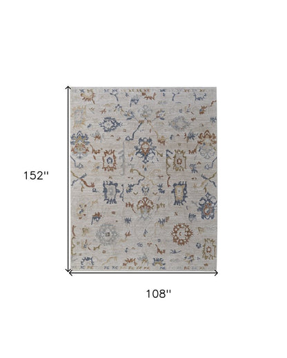 9' X 13' Ivory Blue and Gold Floral Power Loom Worn Faded Area Rug With Fringe